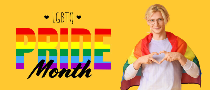 Young man with LGBT flag making heart gesture on yellow background