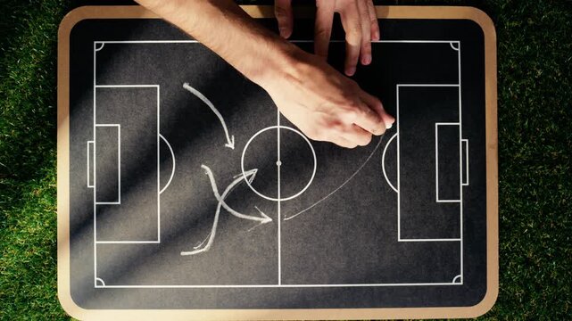 drawing on the blackboard the outline of the football formation