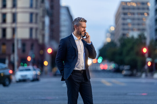 Business man talking on phone outdoor. Businessman negotiation online. Man phone conversation in suit. Hispanic business man founder with phone. Business communication of businessman