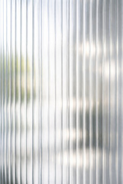 Abstract close-up of corrugated transparent material with reflections