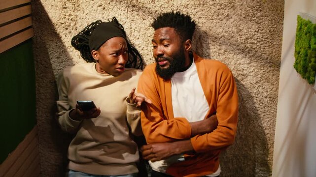 Distant man being rejected by offended displeased woman laying on the floor, bad mood and tension in the toxic relationship. Frustration leading to drama and dispute, troubled life.