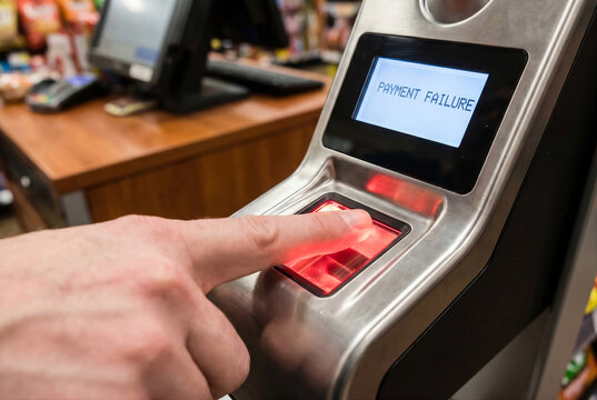 Biometric payment failure on finger scan reader at retail store checkout counter for financial transaction error concept
