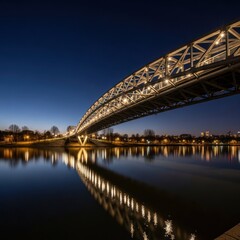 Naklejka premium Illuminated Bridge Arches Over Reflecting River at Night.
