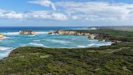 Obraz premium Bay of Islands Coastal Park, Peterborough, Victoria, Australia: 4K aerial drone footage of limestone cliffs, ocean waves, rock stacks and Great Ocean Road coastline.