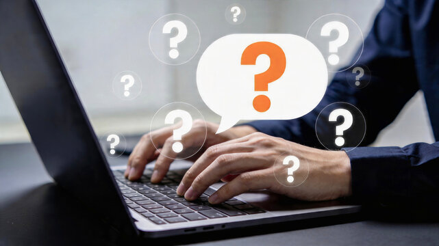 Person typing on a laptop with question marks floating around a speech bubble