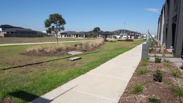 A newly built modern townhouse faces an undeveloped vacant grassland lot in Tarneit, Melbourne's growing western suburb in Australia.&nbsp; A row of completed modern homes&nbsp;across the open undeveloped land
