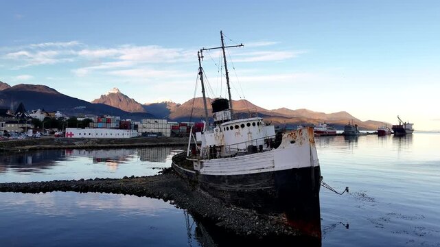 Aerial drone lift revealing the historic Saint Christopher shipwreck grounded in the Beagle Channel with the Martial Mountains in the background