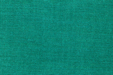 Fototapeta premium Fabric with a solid teal color used in various textile projects during the day
