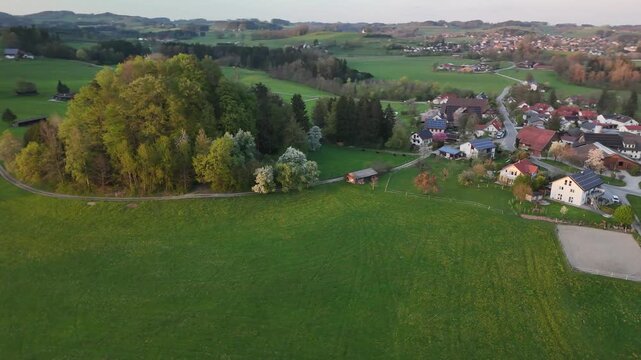 Spring Blooming Landscape with Lush Meadows and Scenic Road at Sunset, Alpine Foothills, Germany Switzerland Austria
