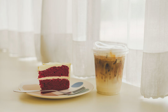 Savoring red velvet cake and iced coffee cozy  dessert experience bright natural light inviting atmosphere sweet indulgence