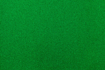 Fototapeta premium Surface covered in green material used for various activities and settings in a well-lit indoor environment during the daytime
