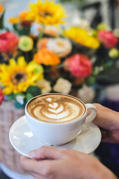 Savoring artisan coffee amidst colorful flowers in a cozy  setting aesthetic experience