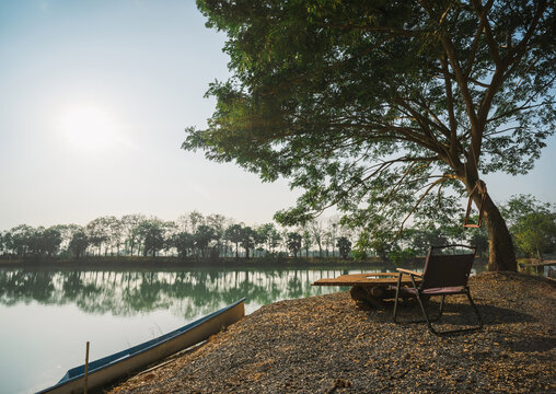 Tranquil morning reflection on lake cozy chair by water nature photography serene atmosphere