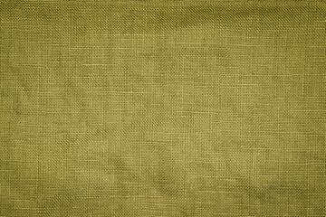 Fototapeta premium Texture of green fabric laid out on a flat surface for background or design use mid-afternoon in a well-lit indoor setting