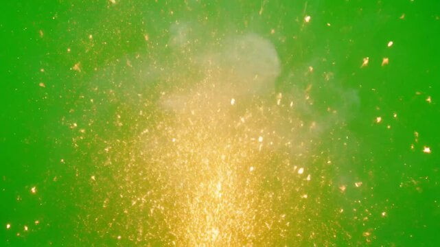 Explosion of bright yellow sparks and light against a vibrant green screen background showing a powerful energetic blast with glowing particles and intense illumination