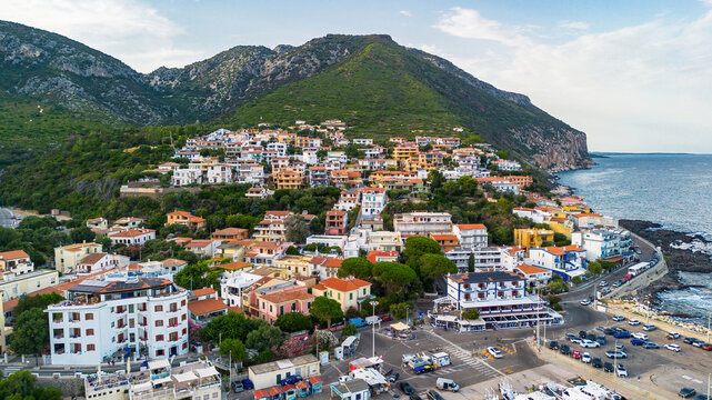Aerial view of the colorful houses and hotels of Cala Gonone coastal town, Gulf of Orosei, Dorgali, Sardinia, Italy