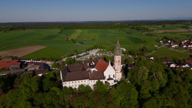 Drone view of Andechs Abbey, located in the municipality of Andechs, Upper Bavaria. A pilgrimage destination with baroque church, beer garden, and scenic Ammersee landscape.