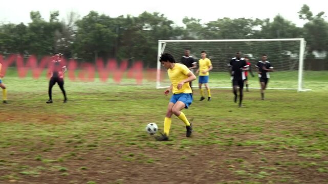 Cross arriving soccer striker dribbling toward goal as backs sliding and GK lunging under watermark