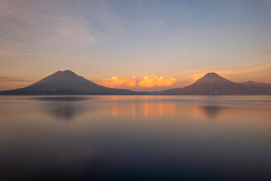 Long exposure of Atitlan Lake with San Pedro, Toliman and Atitlan volcano at sunrise, Panajachel, Guatemala.