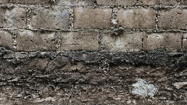 Close up of a wall that was painted at different times so that the texture looks different.