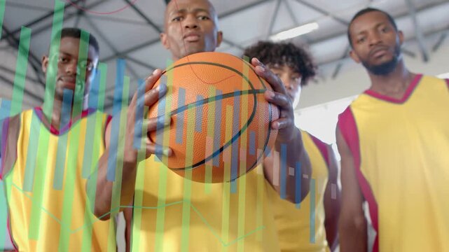 Vertical video: As overlay rising, center Black man moving orange ball closer in gym yellow jerseys