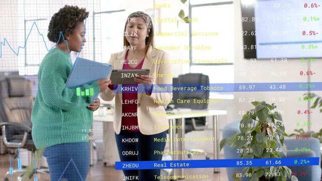 Vertical video: Seeing stock data, beige blazer tapping tablet, green top pointing folder in office