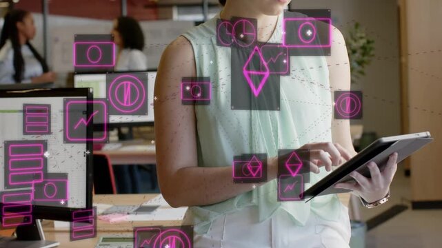 Woman tapping tablet in office, testing pink glyphs layering over hands while coworkers chatting