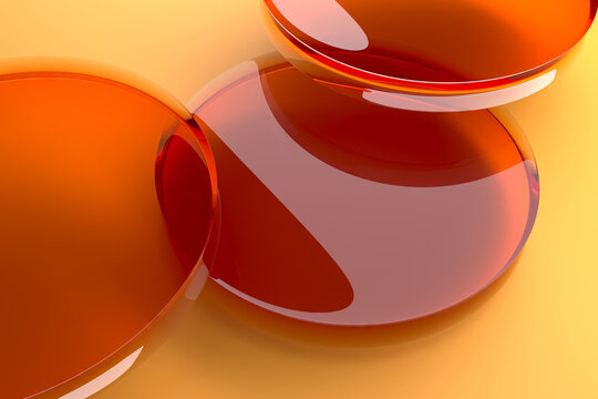 Glossy amber circular liquid discs on warm yellow surface for abstract background and wallpaper design.3d render