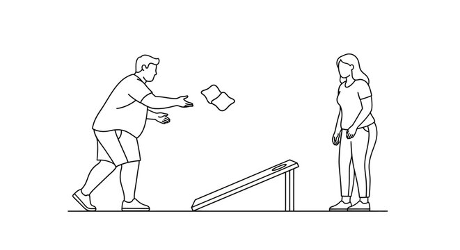 Man throws bean bag at the cornhole board during outdoor game.