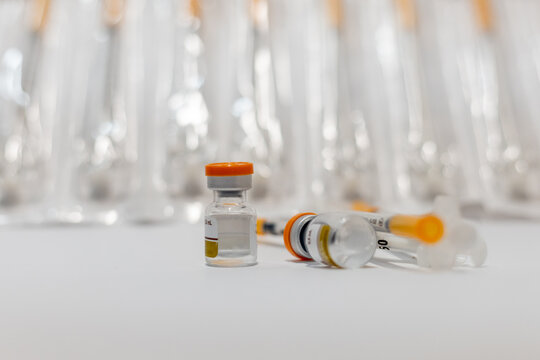 Vials of Tirzepatide medication and insulin syringes for weight loss and diabetes treatment.