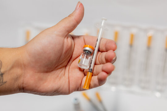 Vials of Tirzepatide medication and insulin syringes for weight loss and diabetes treatment.