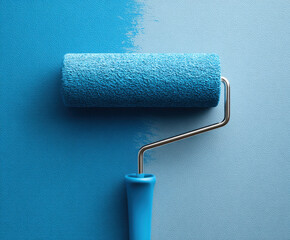 Obraz premium Paint roller on blue wall, close up of textured paint tool for home renovation and interior decorating