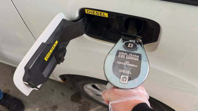 LJUBLJANA, SLOVENIA - MARCH 20, 2026: Close up of a person refueling a diesel car during fuel purchase limits and energy supply restrictions due to the global oil crisis