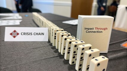 Fototapeta premium Dominoes arranged on a table with branding material representing connection and collaboration in a meeting setting