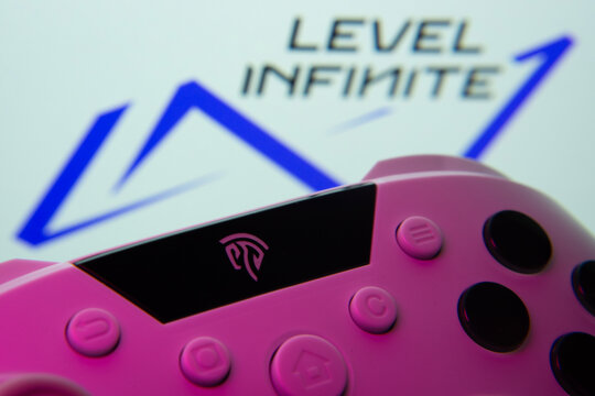 Dhaka, Bangladesh- 24 Mar 2025: A close-up of a gamepad with the Level Infinite seen on screen in the background.