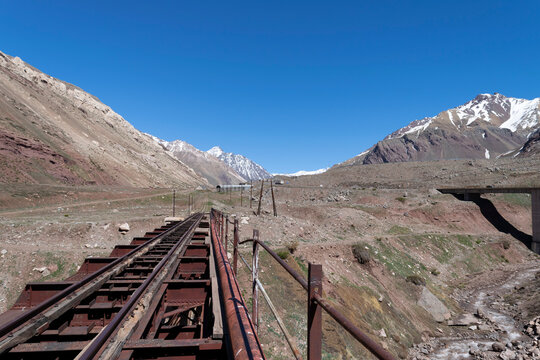 Abandoned trasandino railway bridge crossing andean stream