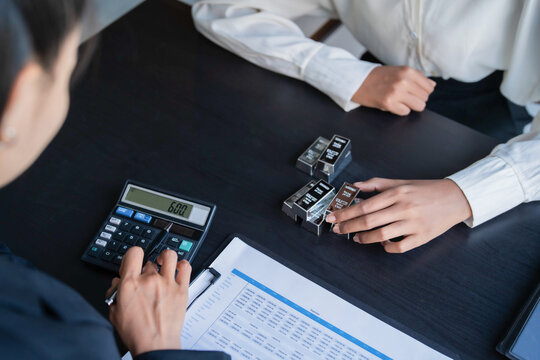 Asian businesswoman holding silver bars for commodity trading and financial investment strategy
