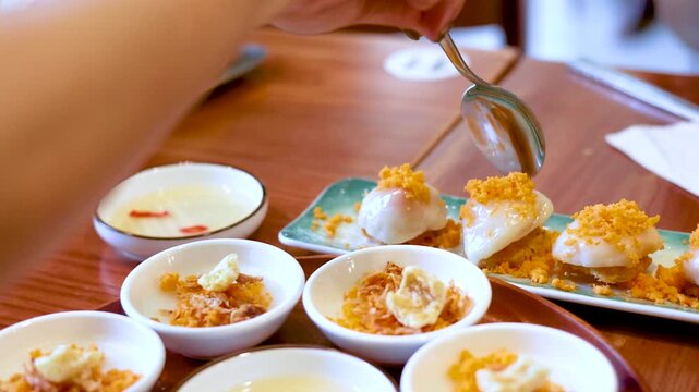 Person Using Spoon to Eat Vietnamese Banh Beo Steamed Rice Cakes