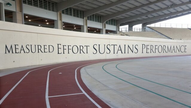 Motivational Wall Quote in Athletic Stadium Promoting Hard Work and Dedication to Sports Performance Improvement