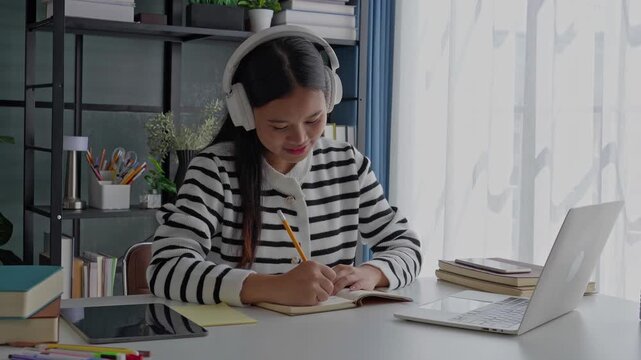 Asian Woman Studying Online on Laptop