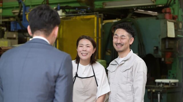 工場で来客対応する夫婦と信金営業や訪問営業マンの打ち合わせビジネスシーン　いらっしゃいませの動画