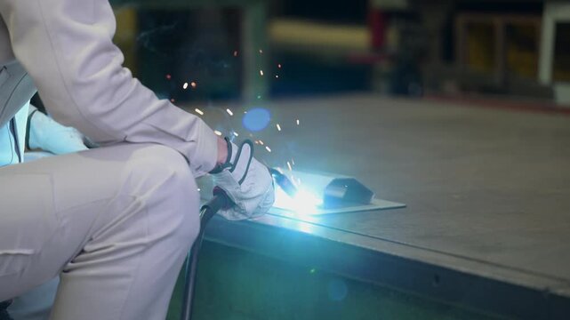 Close-up of metalworking in a manufacturing plant, featuring sparks flying from arc welding&mdash;industrial technology background footage