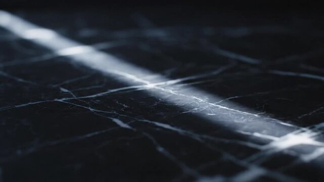 Dramatic light beam shining across a dark polished marble surface with intricate white veining patterns