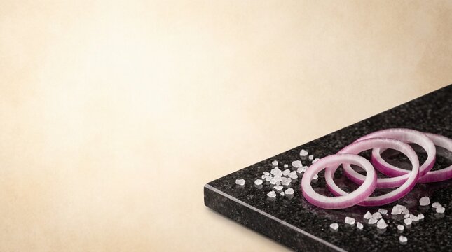 Red onion rings and sea salt on a marble slab for cooking preparation
