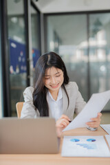 Fototapeta premium Accountant woman working on financial investment on calculator, calculation, business growth analysis and marketing on graph at office.