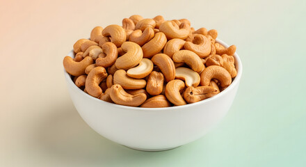 Fototapeta premium Premium Roasted Cashews in White Ceramic Bowl - Healthy Plant-Based Snack with Pastel Aesthetic