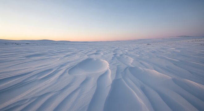Wind sculpted snowdrifts on a barren landscape