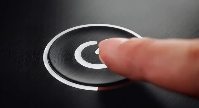 power button closeup on black surface with circular icon