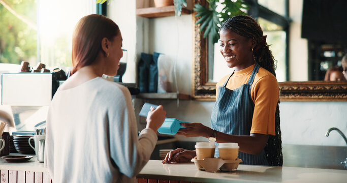 Happy woman, customer and barista with pos machine for credit card payment or purchase in cafe. Female person, checkout or NFC with debit or smile on counter for order or transaction in coffee shop