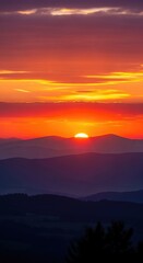 Obraz premium Sunset over the mountains with vibrant colors.